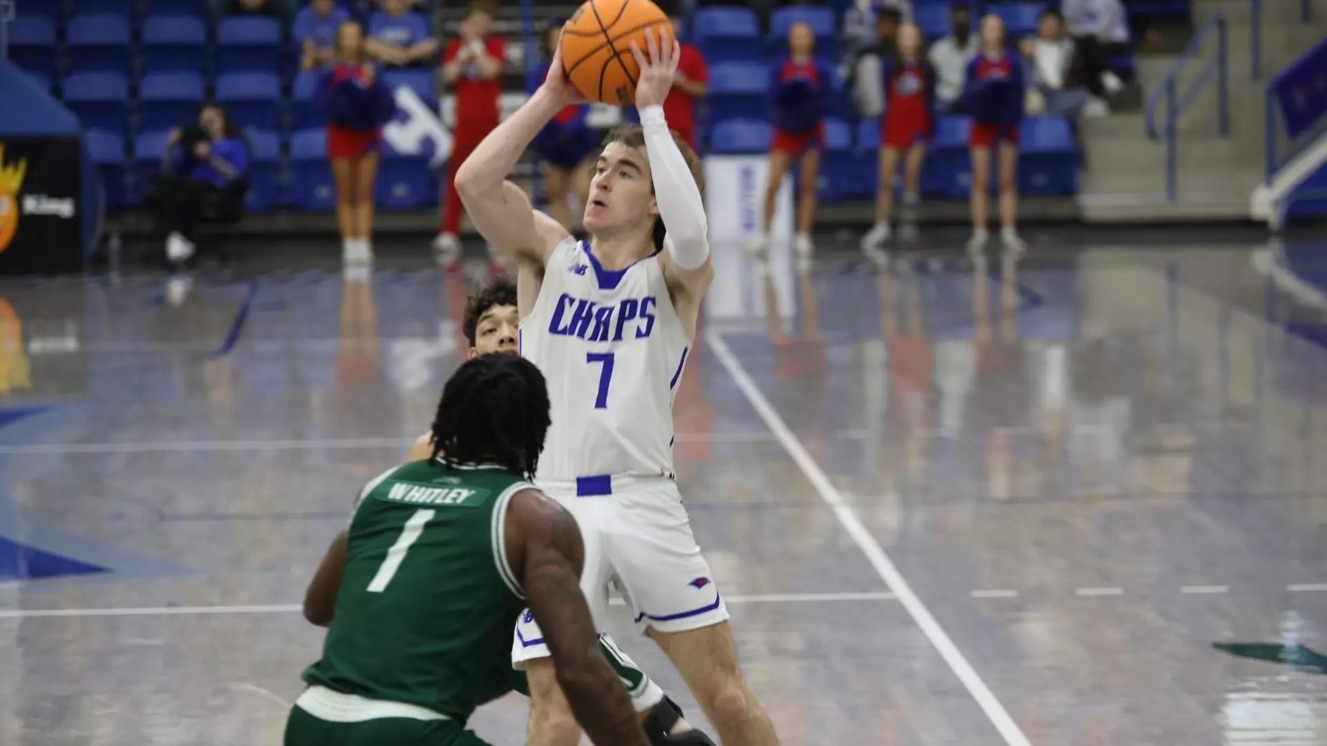Lubbock Christian, in its white home jerseys, drives to the hoop. 