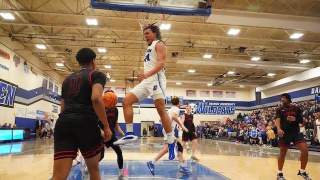 Benjamin Bill dunks it with an agry face in DII men's basketball.