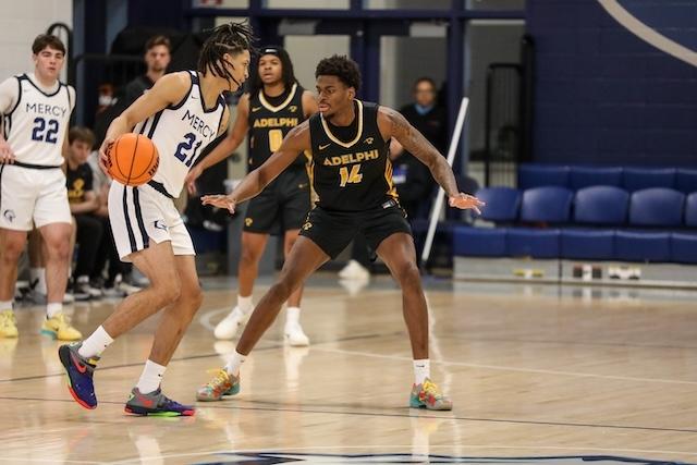 Jarnel Rancy digs in to play defense in DII basketball.